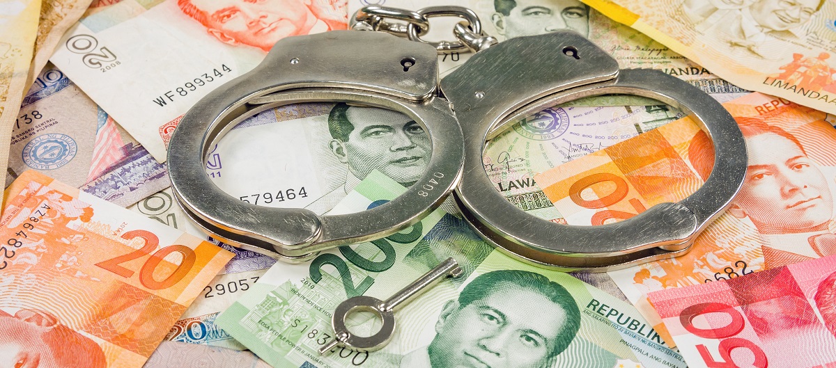 Dirty money and Philippine corruption - handcuffs with world money bills